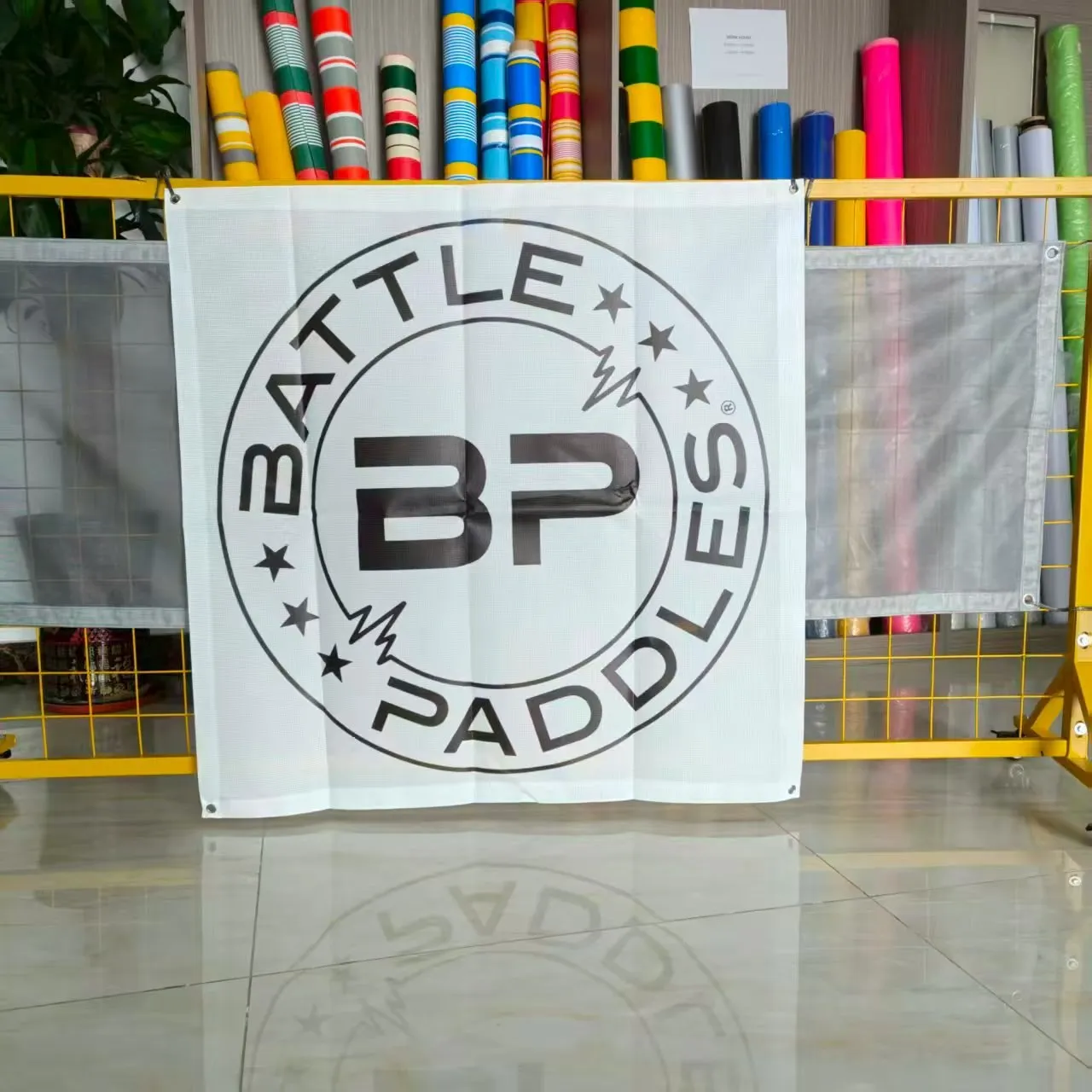 Printed mesh banner with a sports brand graphic hanging at the SKP factory