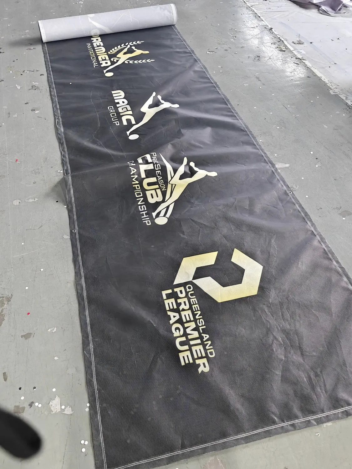Full-length printed PVC mesh banner laid out at the SKP factory before dispatch